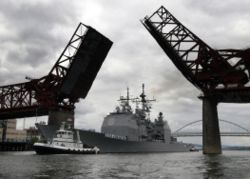 USS Lake Erie, a Ticonderoga-class guided missile cruiser, passes under a drawbridge on the Willamette River